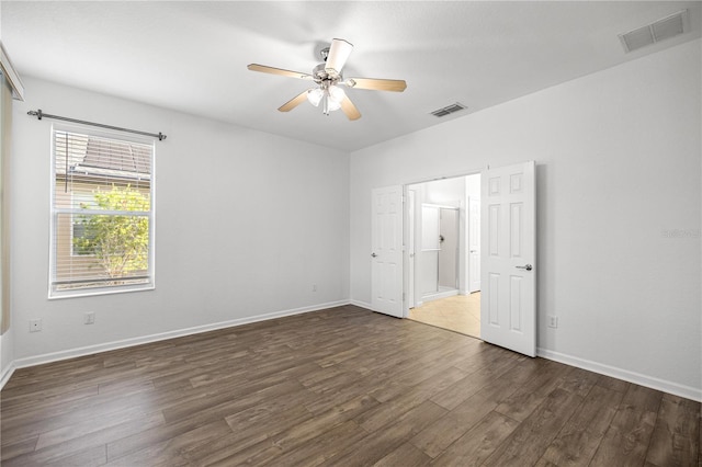 7270 SW 99th Cir, Ocala, FL 34481 - unfurnished bedroom with wood finished floors, baseboards, and a ceiling fan