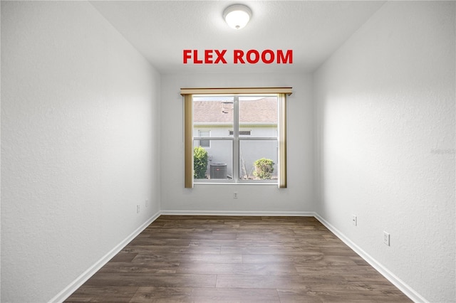 7270 SW 99th Cir, Ocala, FL 34481 - empty room featuring dark wood-style flooring, a textured wall, and baseboards