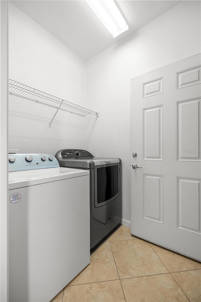 7270 SW 99th Cir, Ocala, FL 34481 - clothes washing area featuring washer and dryer and light tile patterned floors