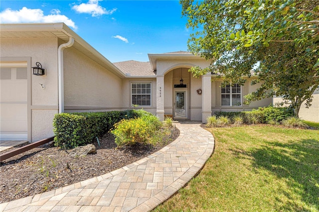 9628 SW 90th St, Ocala, FL 34481 - entrance to property featuring stucco siding, a yard, and a garage