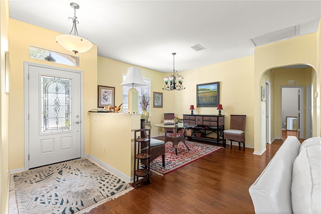 9628 SW 90th St, Ocala, FL 34481 - foyer entrance with plenty of natural light, wood finished floors, arched walkways, and baseboards