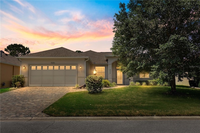 9628 SW 90th St, Ocala, FL 34481 - ranch-style home featuring an attached garage, driveway, stucco siding, and a lawn