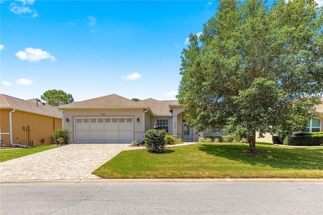 9628 SW 90th St, Ocala, FL 34481 - ranch-style house with an attached garage, stucco siding, decorative driveway, and a front yard