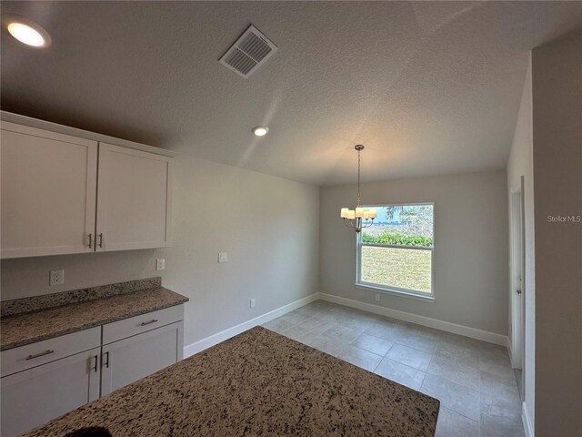 15106 SE 94th Ter, Summerfield, FL 34491 - unfurnished dining area featuring baseboards, a chandelier, light tile patterned floors, a textured ceiling, and recessed lighting