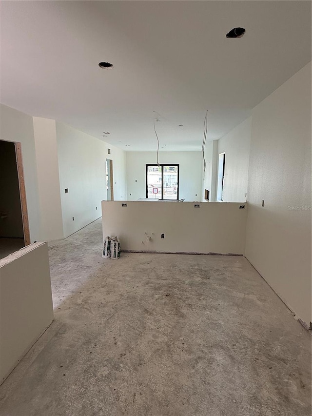 unfurnished room featuring unfinished concrete floors