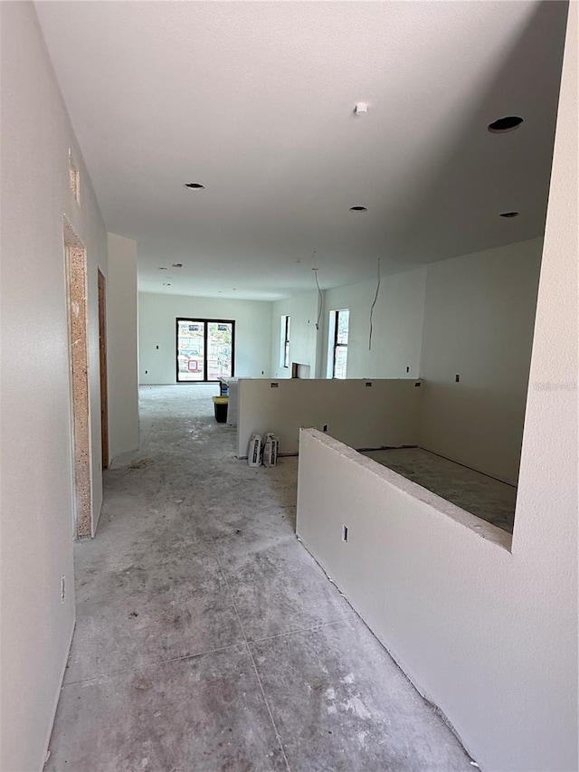 hall featuring concrete floors