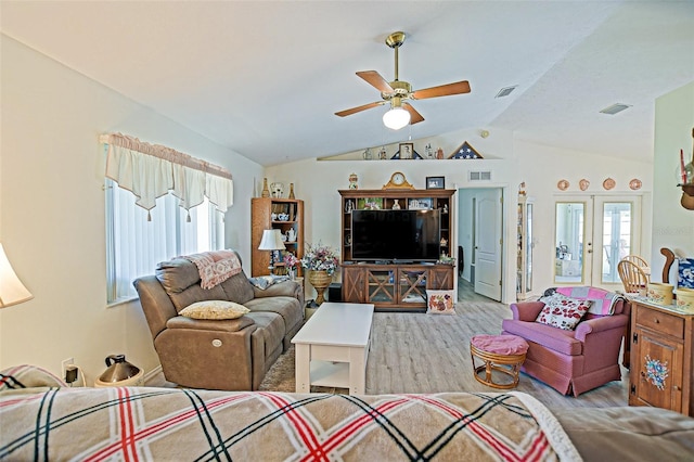 living area with lofted ceiling, wood finished floors, and a ceiling fan