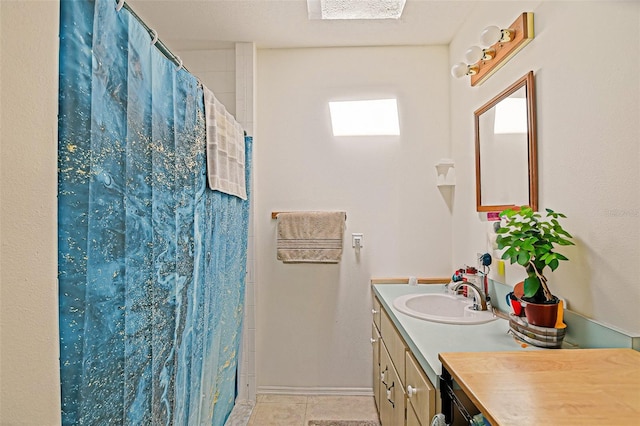 bathroom featuring vanity, tile patterned floors, a shower with shower curtain, and baseboards