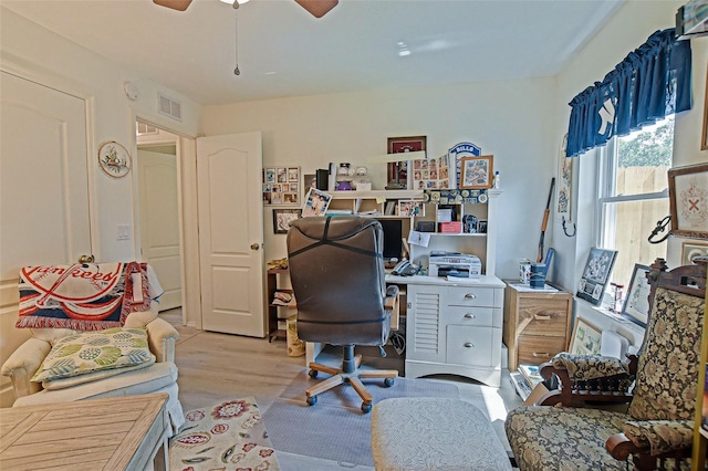 office area with light wood-type flooring and a ceiling fan