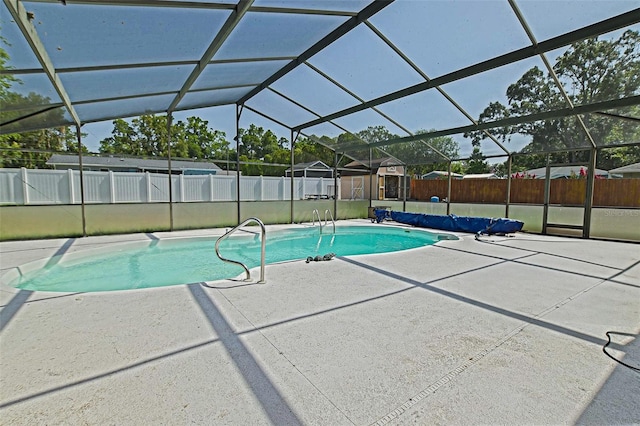 view of swimming pool with a patio area, a fenced backyard, and a lanai