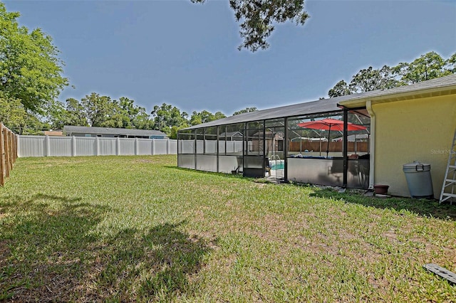 view of yard featuring glass enclosure