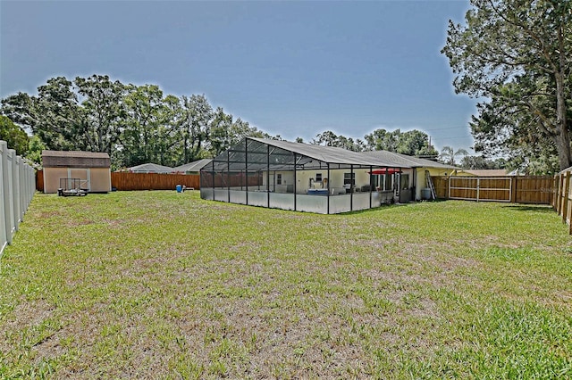 view of yard featuring a shed, an outdoor structure, a swimming pool, and glass enclosure