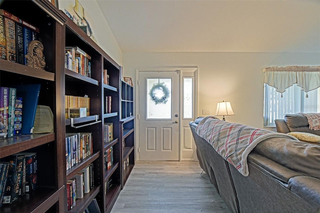 living room with wood finished floors and lofted ceiling