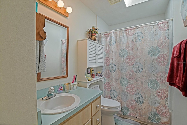 full bathroom with vanity, toilet, and a shower with shower curtain