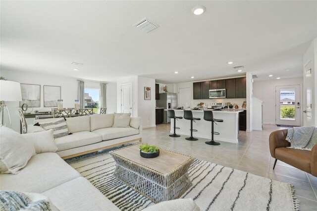 4955 SW 51st Rd, Gainesville, FL 32608 - living room with light tile patterned floors, recessed lighting, and baseboards