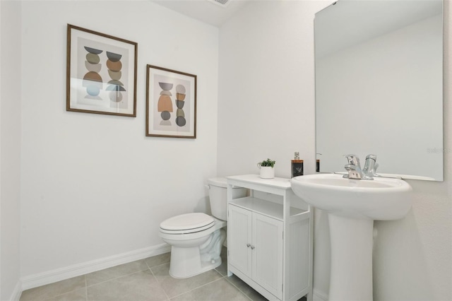 4955 SW 51st Rd, Gainesville, FL 32608 - bathroom featuring toilet, tile patterned floors, and baseboards