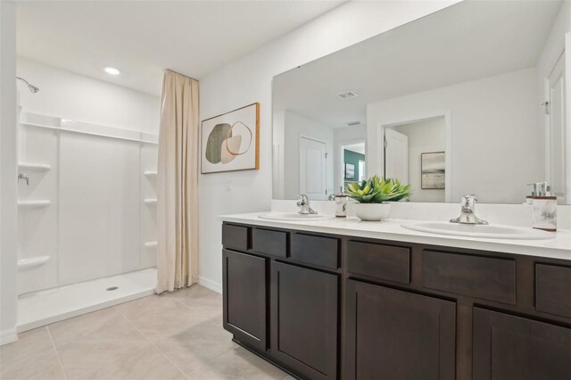 4955 SW 51st Rd, Gainesville, FL 32608 - full bath featuring tile patterned flooring, a stall shower, and double vanity