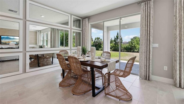 sunroom / solarium featuring tile patterned floors and baseboards