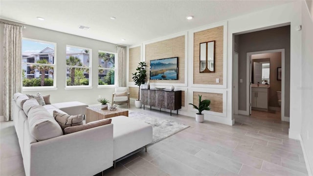 living room with recessed lighting and baseboards