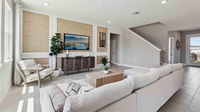 living area featuring recessed lighting, tile patterned floors, stairs, and baseboards