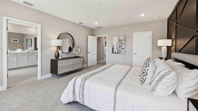 bedroom with light carpet, connected bathroom, recessed lighting, and baseboards