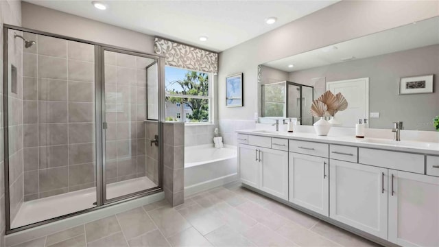 full bathroom featuring a shower stall, double vanity, a bath, tile patterned flooring, and recessed lighting