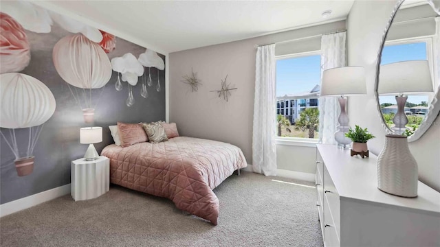 carpeted bedroom featuring baseboards