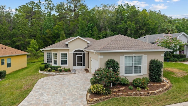 2631 SW 20th Cir, Ocala, FL 34471 - ranch-style home with a garage, decorative driveway, a front lawn, stucco siding, and a shingled roof