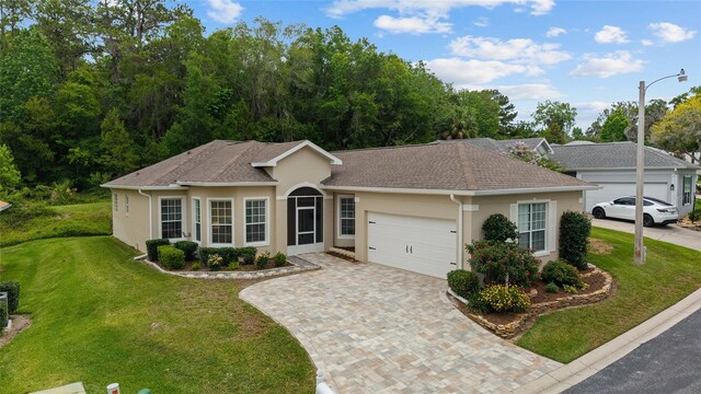 2631 SW 20th Cir, Ocala, FL 34471 - ranch-style home featuring a garage, stucco siding, a front lawn, and decorative driveway