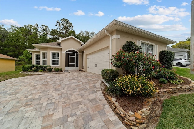 2631 SW 20th Cir, Ocala, FL 34471 - view of front of house with an attached garage, driveway, and stucco siding