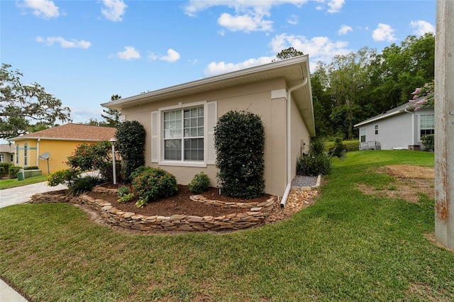 2631 SW 20th Cir, Ocala, FL 34471 - view of side of home with a lawn and stucco siding