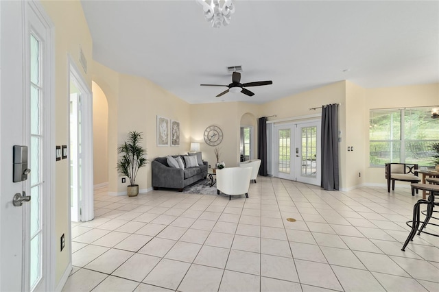 2631 SW 20th Cir, Ocala, FL 34471 - living room featuring arched walkways, french doors, light tile patterned floors, and a ceiling fan