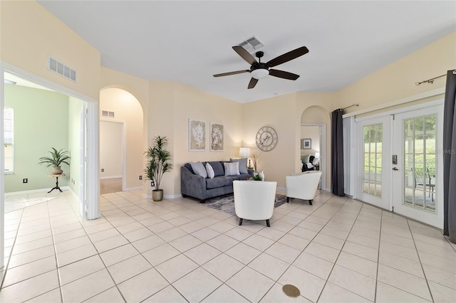 2631 SW 20th Cir, Ocala, FL 34471 - living area with arched walkways, ceiling fan, light tile patterned flooring, and french doors
