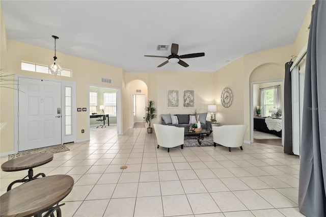 2631 SW 20th Cir, Ocala, FL 34471 - foyer entrance with a ceiling fan, arched walkways, light tile patterned flooring, and baseboards