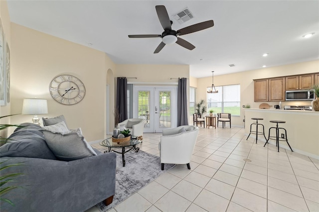 2631 SW 20th Cir, Ocala, FL 34471 - living area featuring light tile patterned flooring, ceiling fan, arched walkways, recessed lighting, and french doors