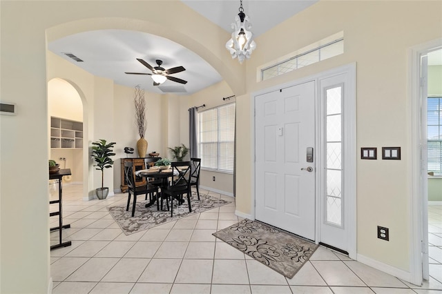 2631 SW 20th Cir, Ocala, FL 34471 - foyer featuring light tile patterned floors, ceiling fan, arched walkways, and baseboards