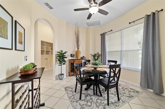 2631 SW 20th Cir, Ocala, FL 34471 - dining space with arched walkways, light tile patterned floors, ceiling fan, and baseboards
