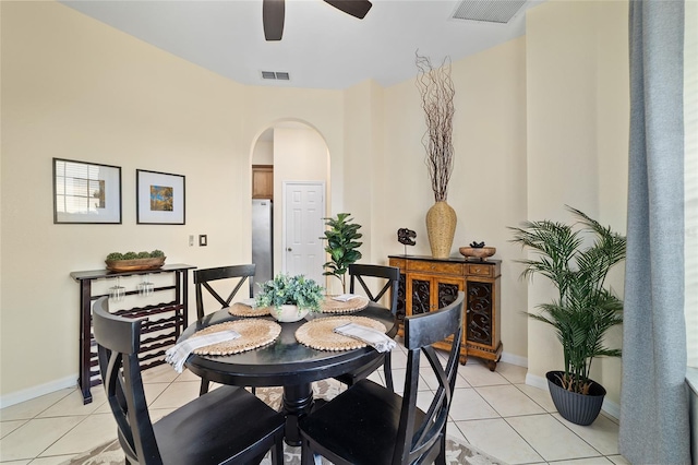2631 SW 20th Cir, Ocala, FL 34471 - dining room featuring arched walkways, light tile patterned floors, a ceiling fan, and baseboards