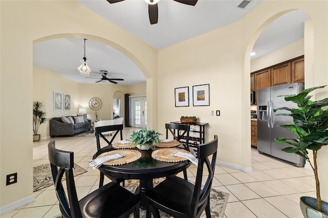 2631 SW 20th Cir, Ocala, FL 34471 - dining space with ceiling fan, light tile patterned floors, arched walkways, and baseboards