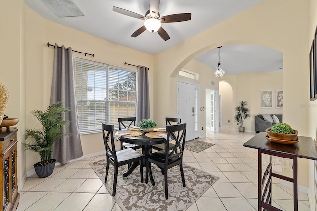 2631 SW 20th Cir, Ocala, FL 34471 - dining space featuring arched walkways, ceiling fan, light tile patterned flooring, and baseboards