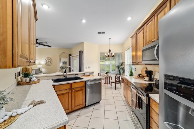 2631 SW 20th Cir, Ocala, FL 34471 - kitchen featuring appliances with stainless steel finishes, a sink, light countertops, brown cabinetry, and recessed lighting