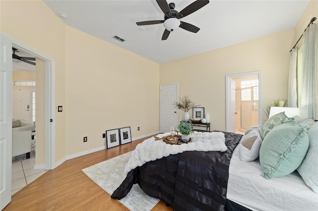 2631 SW 20th Cir, Ocala, FL 34471 - bedroom with light wood-style flooring, ceiling fan, connected bathroom, and baseboards