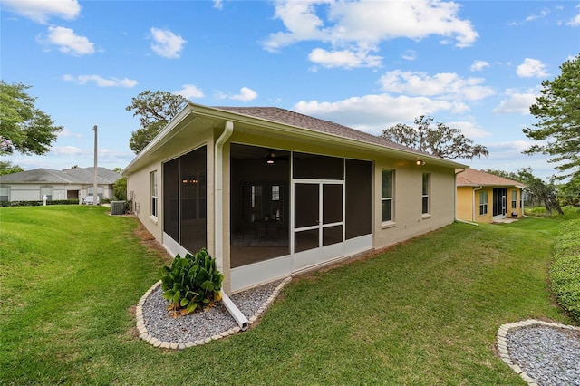 2631 SW 20th Cir, Ocala, FL 34471 - back of property featuring a sunroom, a yard, central AC, and stucco siding