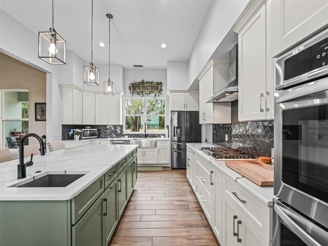 5330 NE 111th Lane Rd, Anthony, FL 32617 - kitchen featuring a sink, appliances with stainless steel finishes, green cabinetry, wall chimney exhaust hood, and recessed lighting