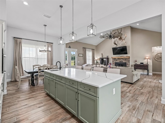 5330 NE 111th Lane Rd, Anthony, FL 32617 - kitchen featuring green cabinetry, a fireplace, light wood-type flooring, recessed lighting, and a sink