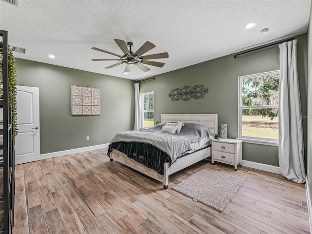 5330 NE 111th Lane Rd, Anthony, FL 32617 - bedroom featuring a textured ceiling, wood finished floors, baseboards, recessed lighting, and a ceiling fan