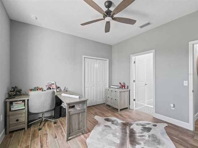 5330 NE 111th Lane Rd, Anthony, FL 32617 - home office with a ceiling fan, light wood-style floors, and baseboards