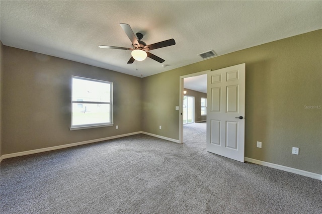 6443 NW 57th Ct, Ocala, FL 34482 - spare room with ceiling fan, a textured ceiling, carpet flooring, and baseboards