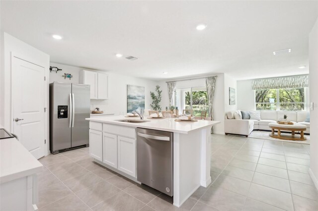 4683 SW 88th Ln, Ocala, FL 34476 - kitchen featuring stainless steel appliances, a sink, open floor plan, white cabinetry, and light tile patterned floors