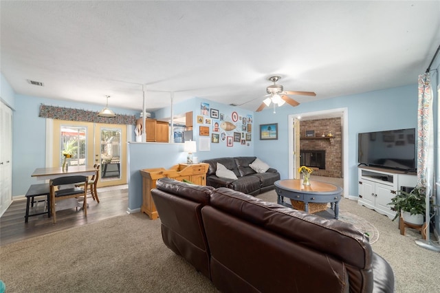 6060 SE 119th Pl, Belleview, FL 34420 - living area featuring carpet, ceiling fan, a fireplace, and baseboards